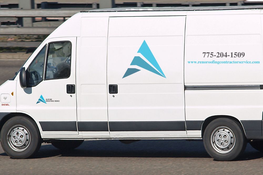 A white van adorned with a blue logo, signifying a roofing service operating in Reno, NV.
